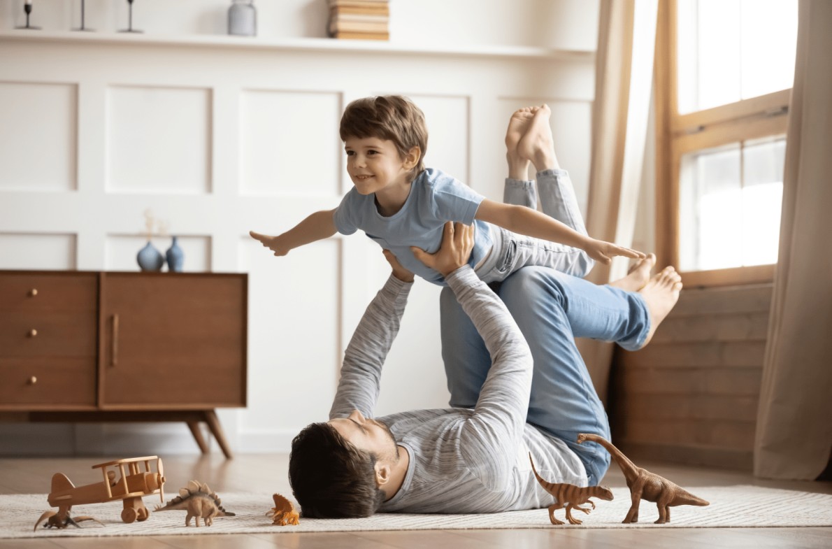 Father and son happily enjoy their new living room, thanks to Amerisave's easy mortgage options